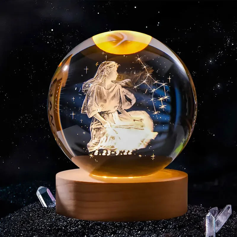 A crystal ball with a golden orb and an engraved image of a praying figure against a starry background.