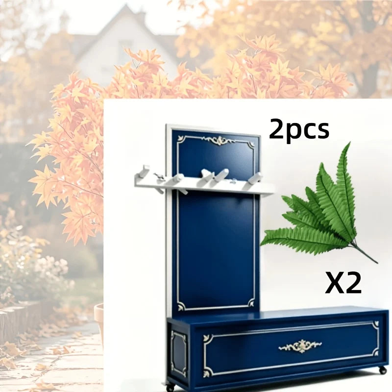 A pair of artificial Boston ferns in a dark blue decorative planter box.