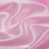 Close-up of flowing pink satin fabric with soft folds and highlights.