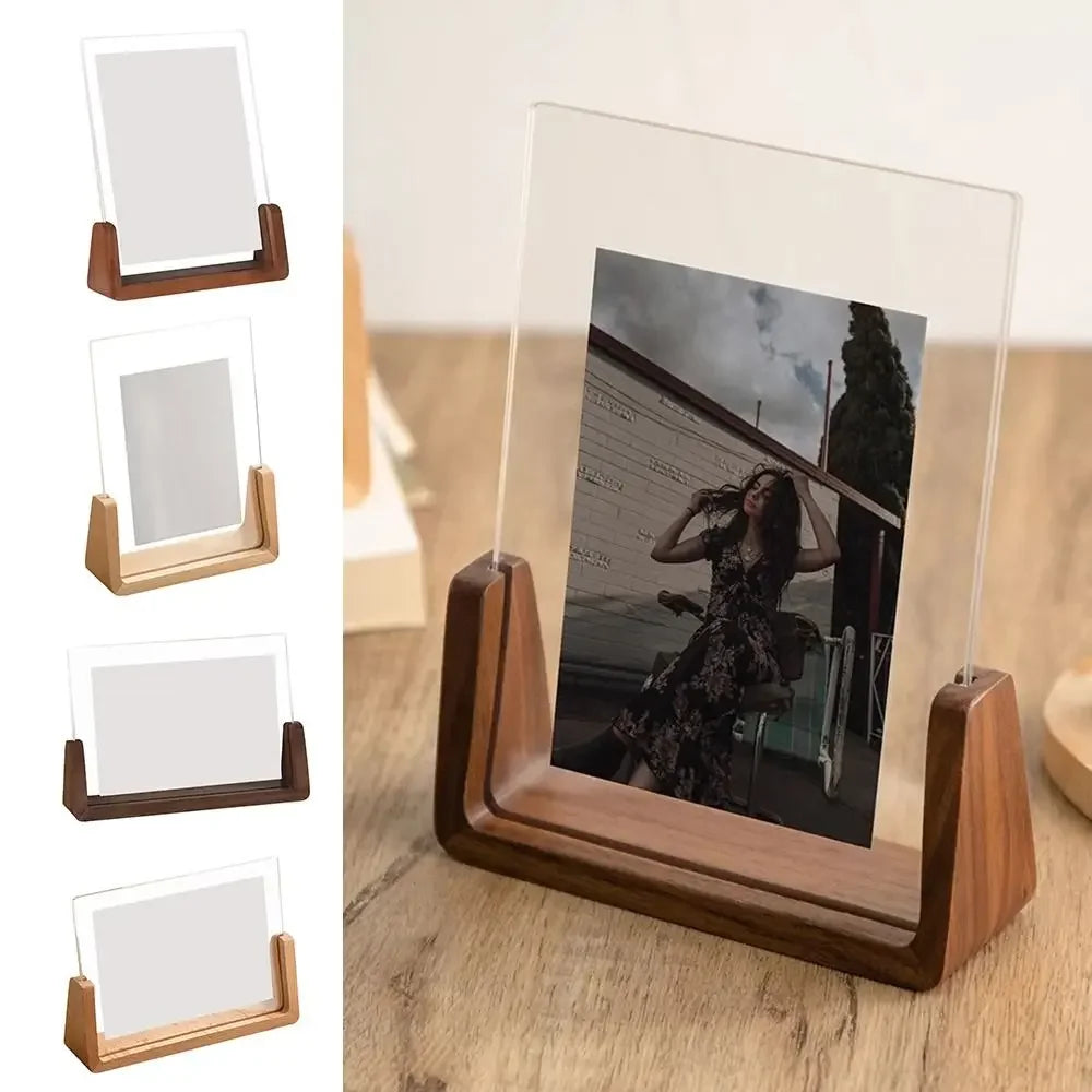 A set of walnut wood and acrylic photo frames displayed on a wooden surface.