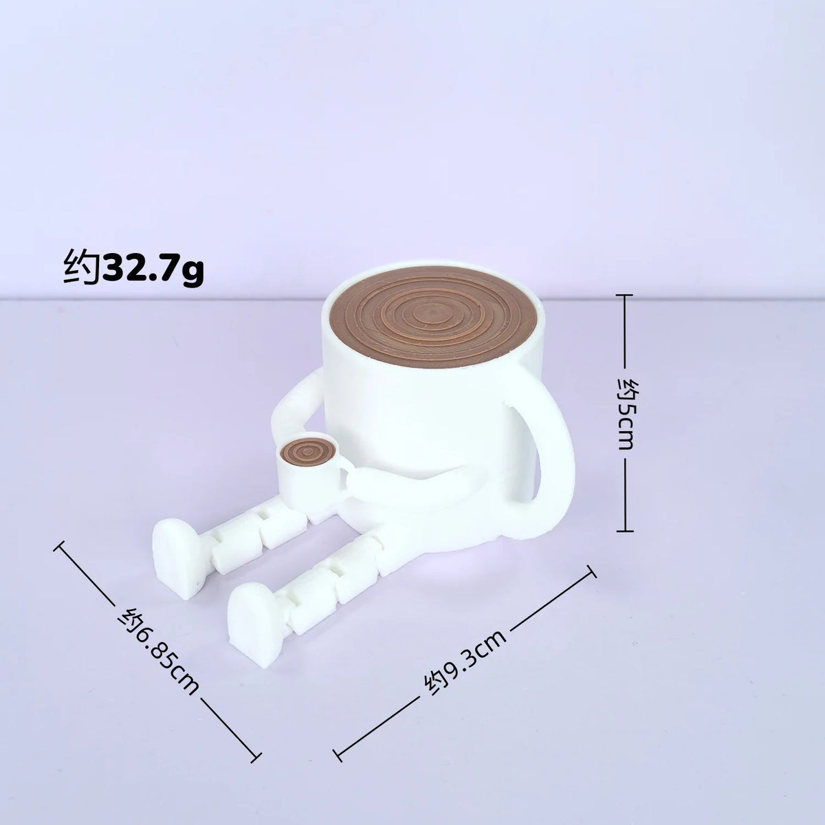 A white 3D printed figurine of a coffee bean cup with articulated joints, shown on a light purple surface.