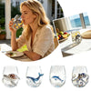 A collection of handcrafted stemless wine glasses featuring blue-ringed octopus and fish designs.