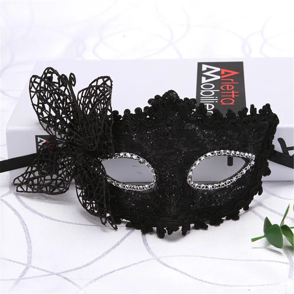 Black lace half-face mask with silver detailing displayed on a white background.