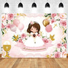 A pink and gold floral backdrop featuring a girl in a white dress for a First Communion celebration.