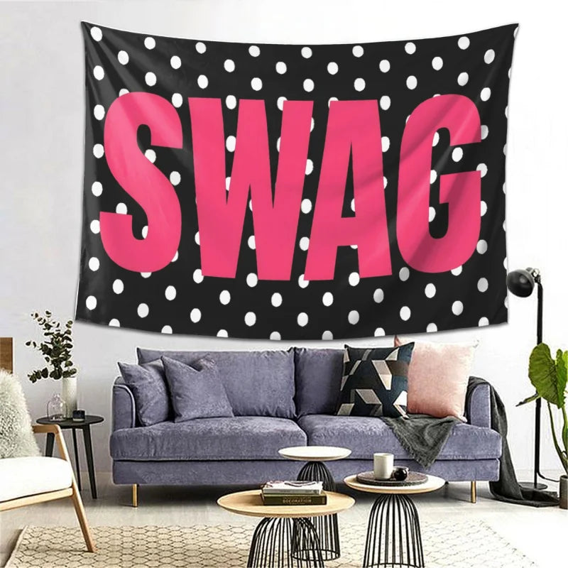 A pink polka dot tapestry featuring the word SWAG displayed on a dark background.