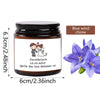 A dark glass jar candle with a label featuring a silhouette of a couple and the text Daniel & Canla for a blue wind chime gif