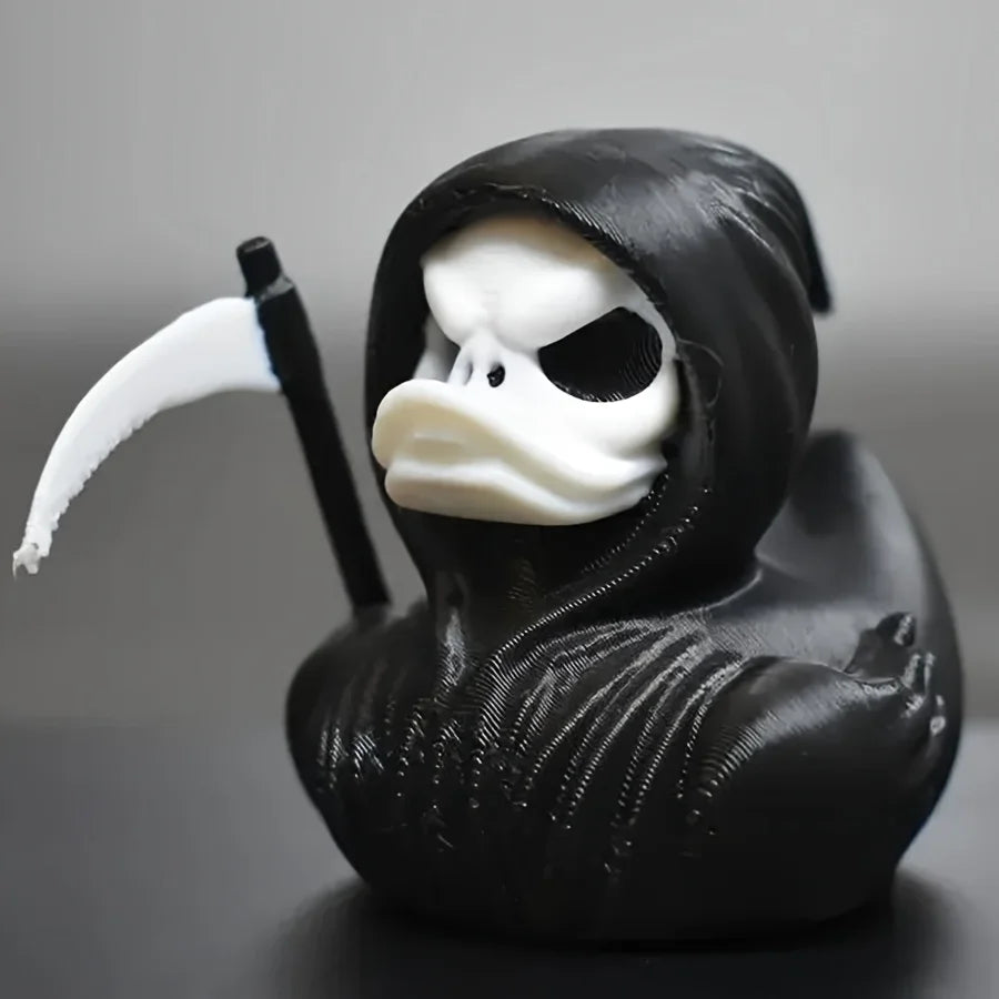 A black 3D printed statue of a Grim Reaper duck with a hood and a scythe.