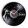 A black vinyl record is used as a wall clock with a white hand pointing to the twelve o'clock position.