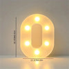 A glowing letter O made of LED lights, used for cozy room and party decor.
