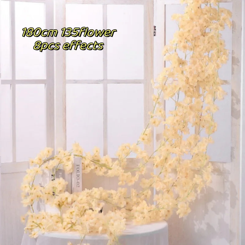 A long, cascading garland of yellow flowers is displayed in front of a white wooden window frame.