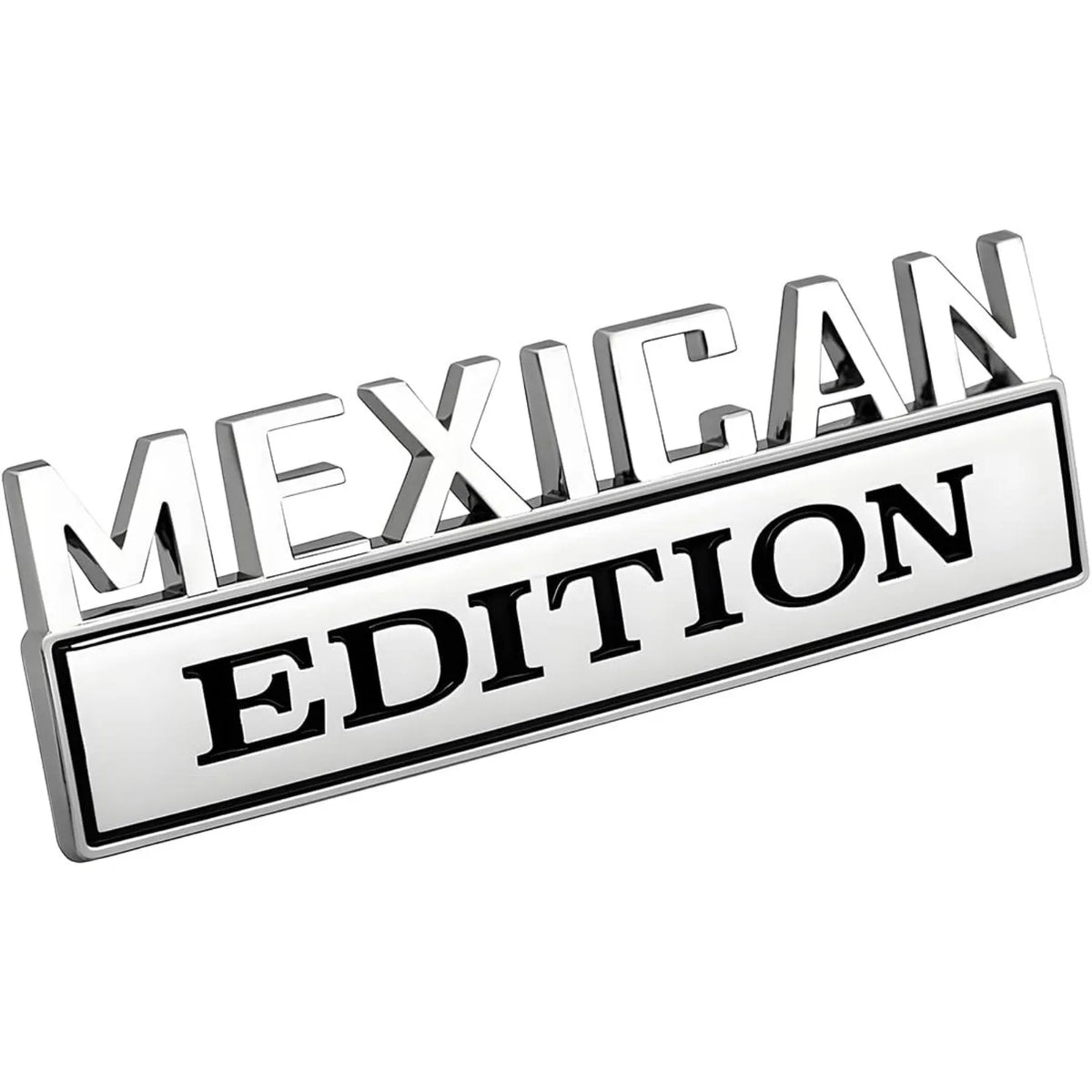 A silver metal emblem with the text MEXICAN EDITION engraved on a rectangular plaque.
