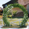 An archway decorated with green ivy and white flowers for outdoor event or garden decor.