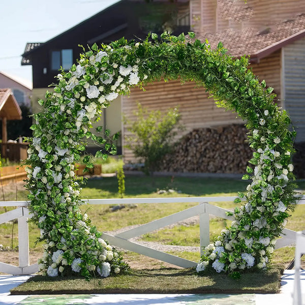 An archway decorated with green ivy and white flowers for outdoor event or garden decor.