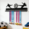 A black metal display rack with 20 hooks for wall mounting, featuring soccer-themed silhouettes and colorful medals.