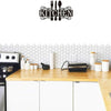 Black metal wall art sign featuring a silhouette of cutlery spelling out the word KITCHEN