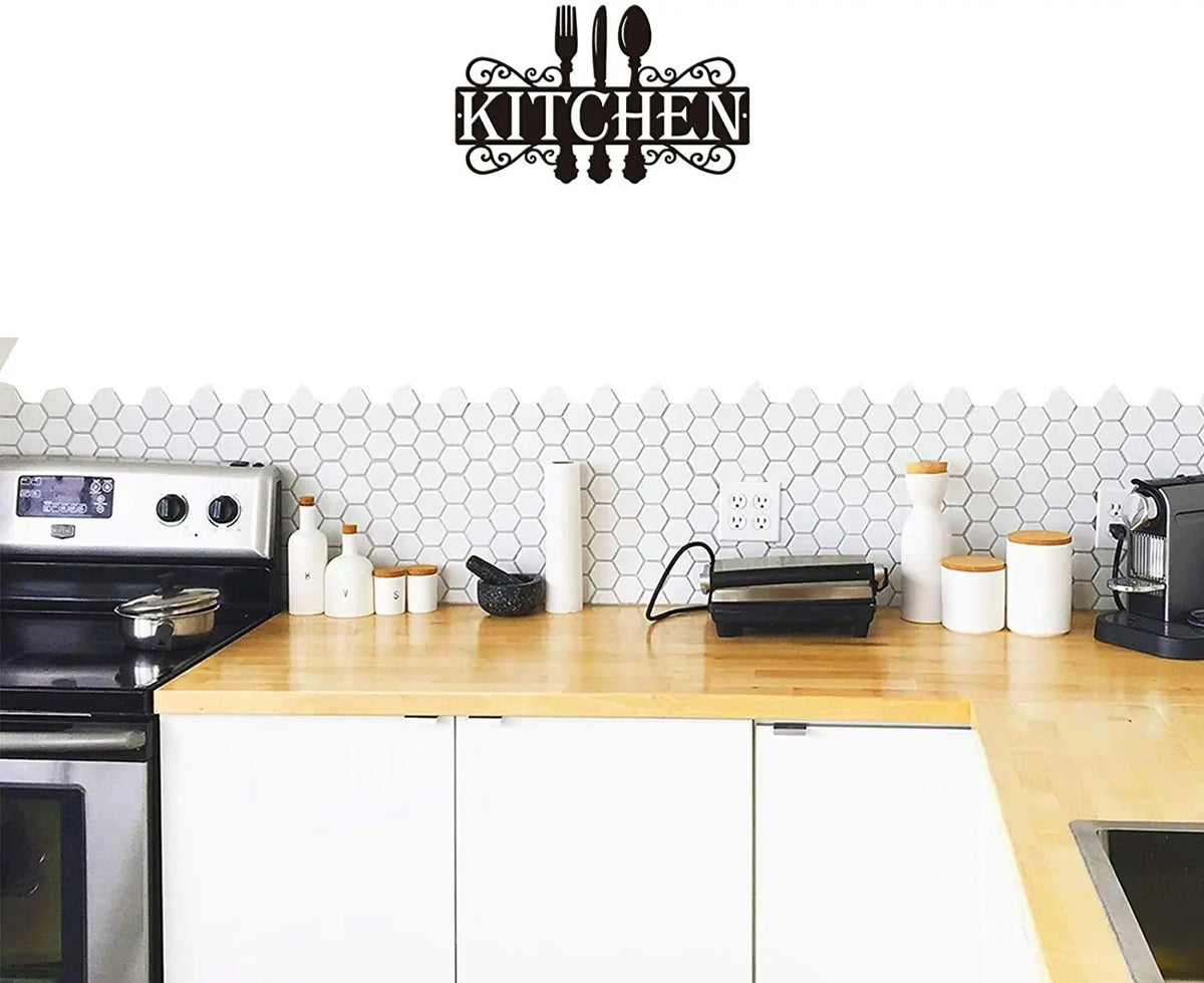 Black metal wall art sign featuring a silhouette of cutlery spelling out the word KITCHEN