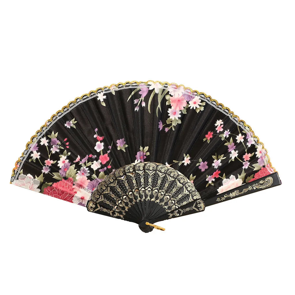 A vintage lace hand fan featuring black fabric with pink and purple floral embroidery.