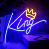 A neon sign shaped like a crown and the word King glowing bright blue on a dark background.