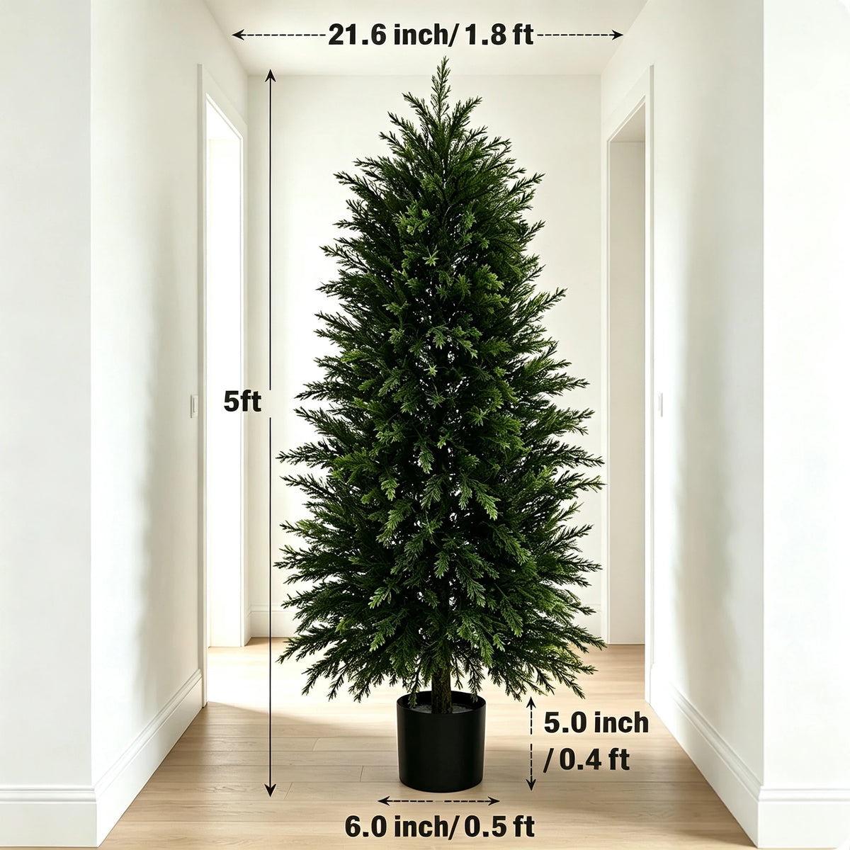 A tall artificial cedar topiary tree standing in a hallway with wooden flooring and white walls.