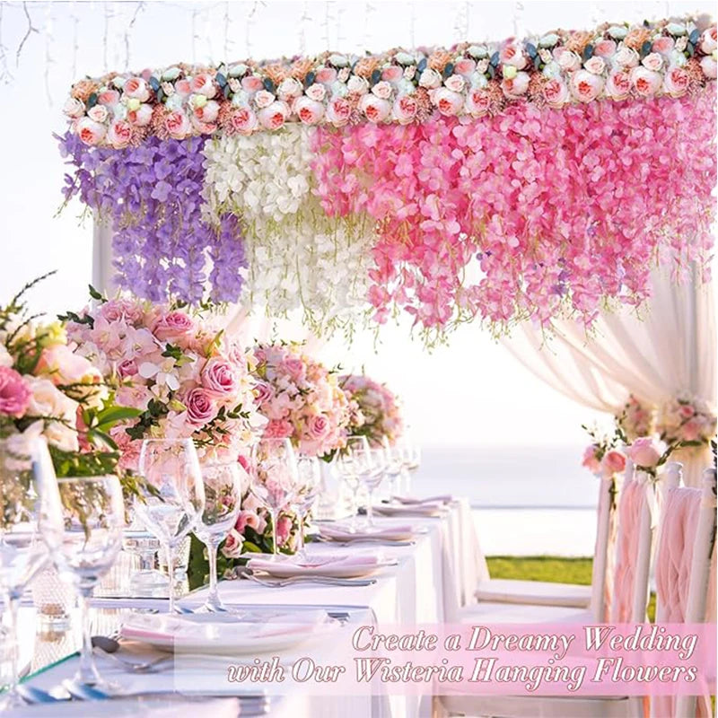 A wedding table decorated with pink and purple artificial wisteria hanging flowers.