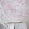 A white tapestry wall hanging featuring a sweet dream theme with pink and white cartoon characters and hearts.