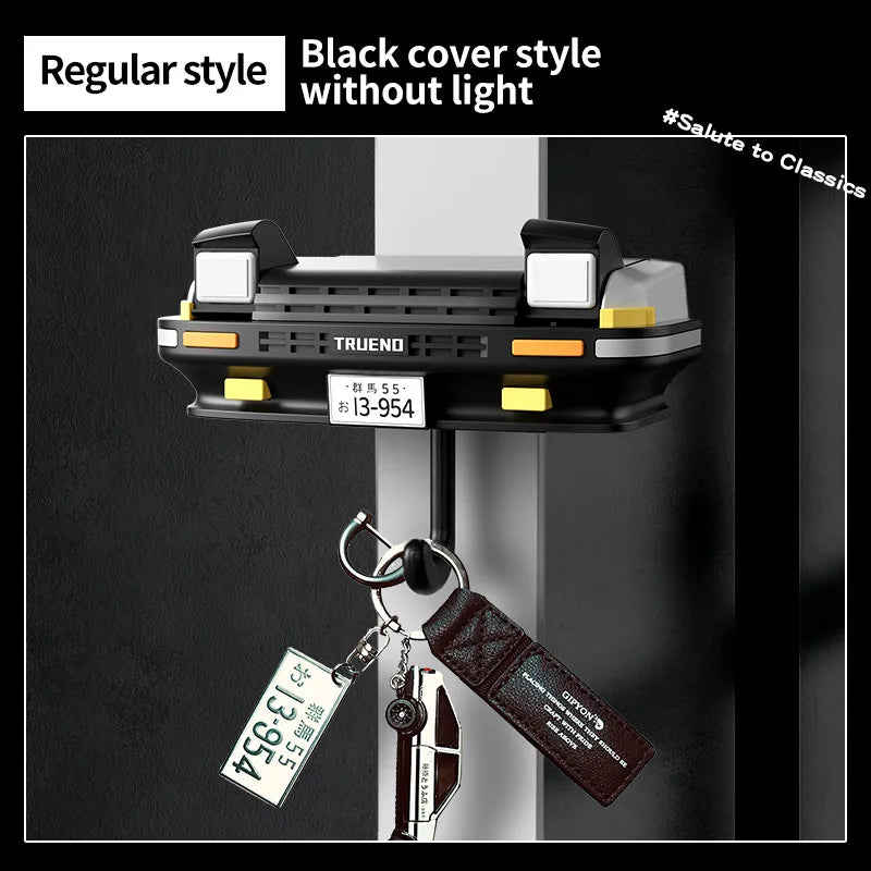 Black cover style headlight key holder with a brass key attached