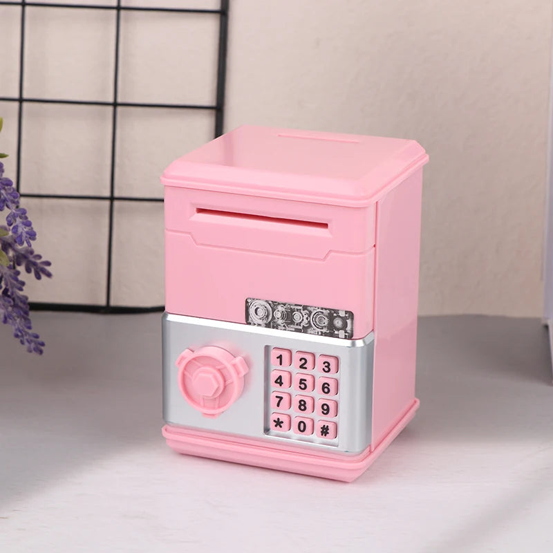 A pink kids mini piggy bank and money box with a silver keypad is shown on a light surface.