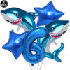 A blue shark foil balloon decoration with a toothy smile, used for an ocean-themed party.
