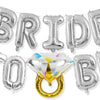 A silver balloon garland spelling BRIDE TO BE, featuring a gold ring accent.