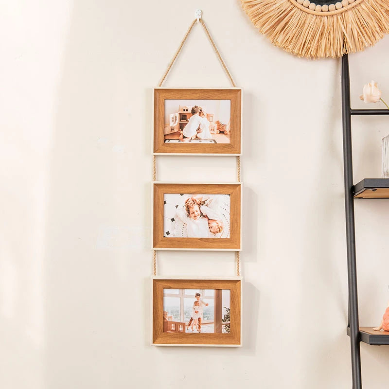 A vertical display of four rustic wooden collage photo frames hanging on a wall.