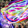 Colorful LED glow wands with ribbons and bells flowing in the air for a wedding or party