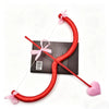 Red heart shaped bow and arrow prop with pink ribbon for costumes and parties