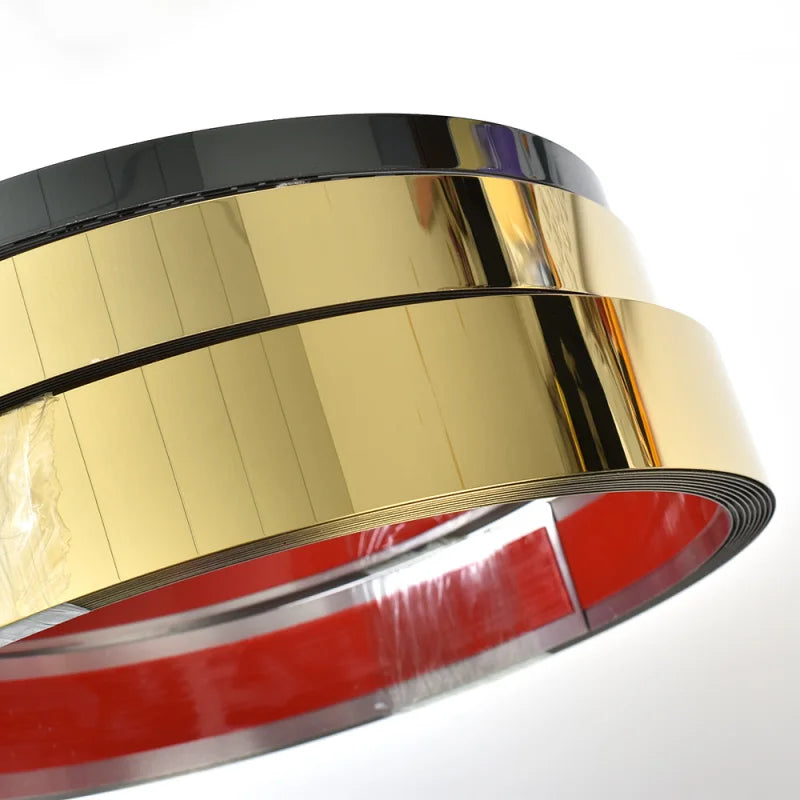 Close-up view of gold mirror self-adhesive stainless steel decorative wall trim with a red inner lining.