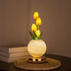A yellow tulip LED night light with touch dimming and USB rechargeable battery displayed on a woven mat.