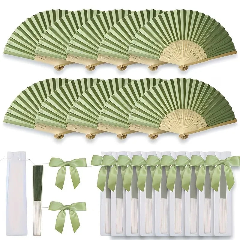 A set of green and beige handheld folding wedding fans with ribbon ties.