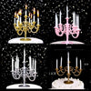 A set of nine elegant birthday cake candles with ornate gold and pink holders displayed against a black background.