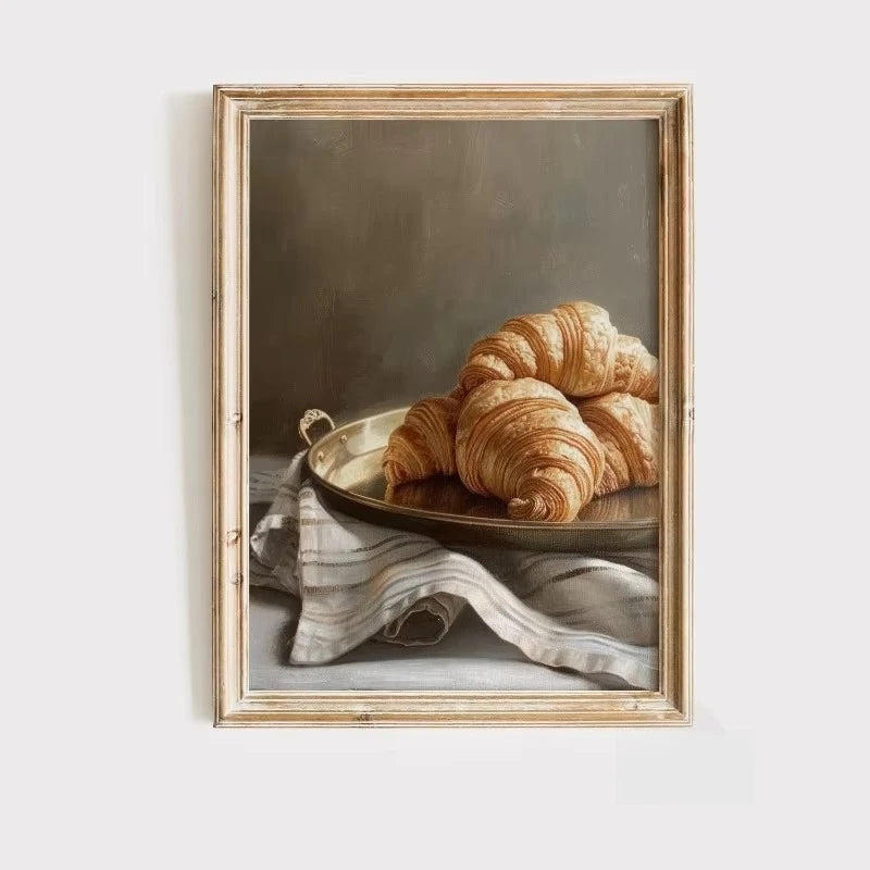 A painting featuring golden croissants resting on a plate with a draped linen cloth.