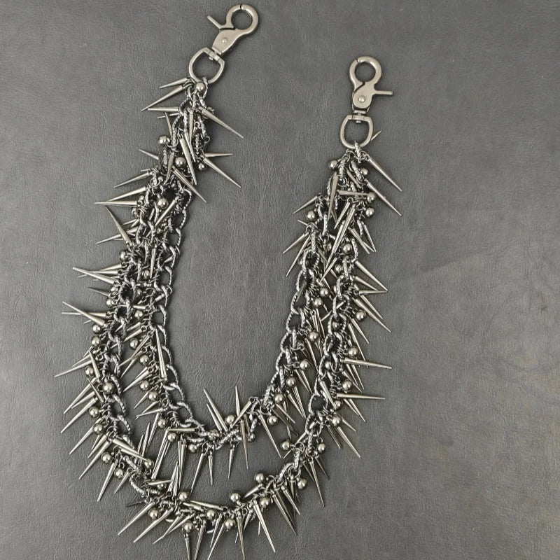 A silver chain necklace featuring sharp metal rivets and spikes, designed in a heavy punk biker style.