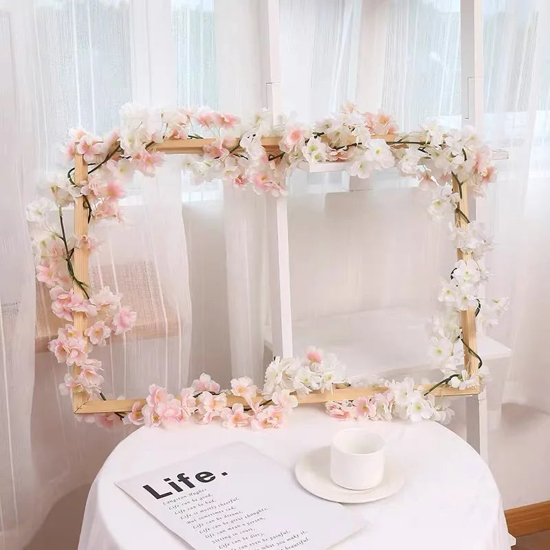 Pink sakura flower garland displayed on a wooden arch for weddings and events