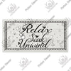 Rustic wooden toilet wall sign with the text Relax Soak Unwind carved into the wood.