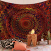 A bohemian mandala tapestry wall art featuring intricate, swirling patterns in deep reds, oranges, and blues.