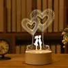 A wireframe heart decoration featuring a couple silhouette on a round base.