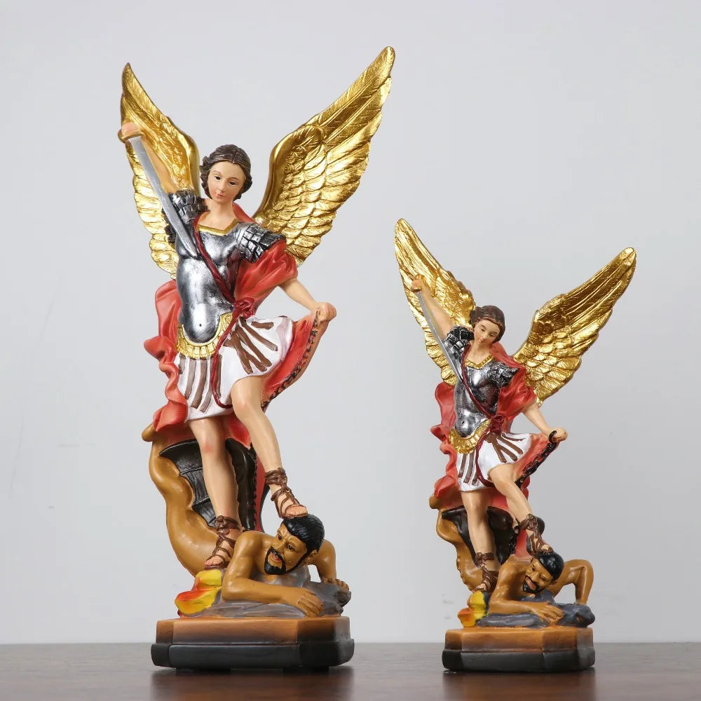 A resin statue of Saint Michael the Archangel with golden wings and armor.