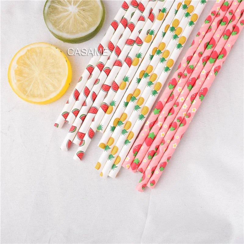 A collection of colorful striped and polka dot paper drinking straws in various pink, white, and yellow patterns.