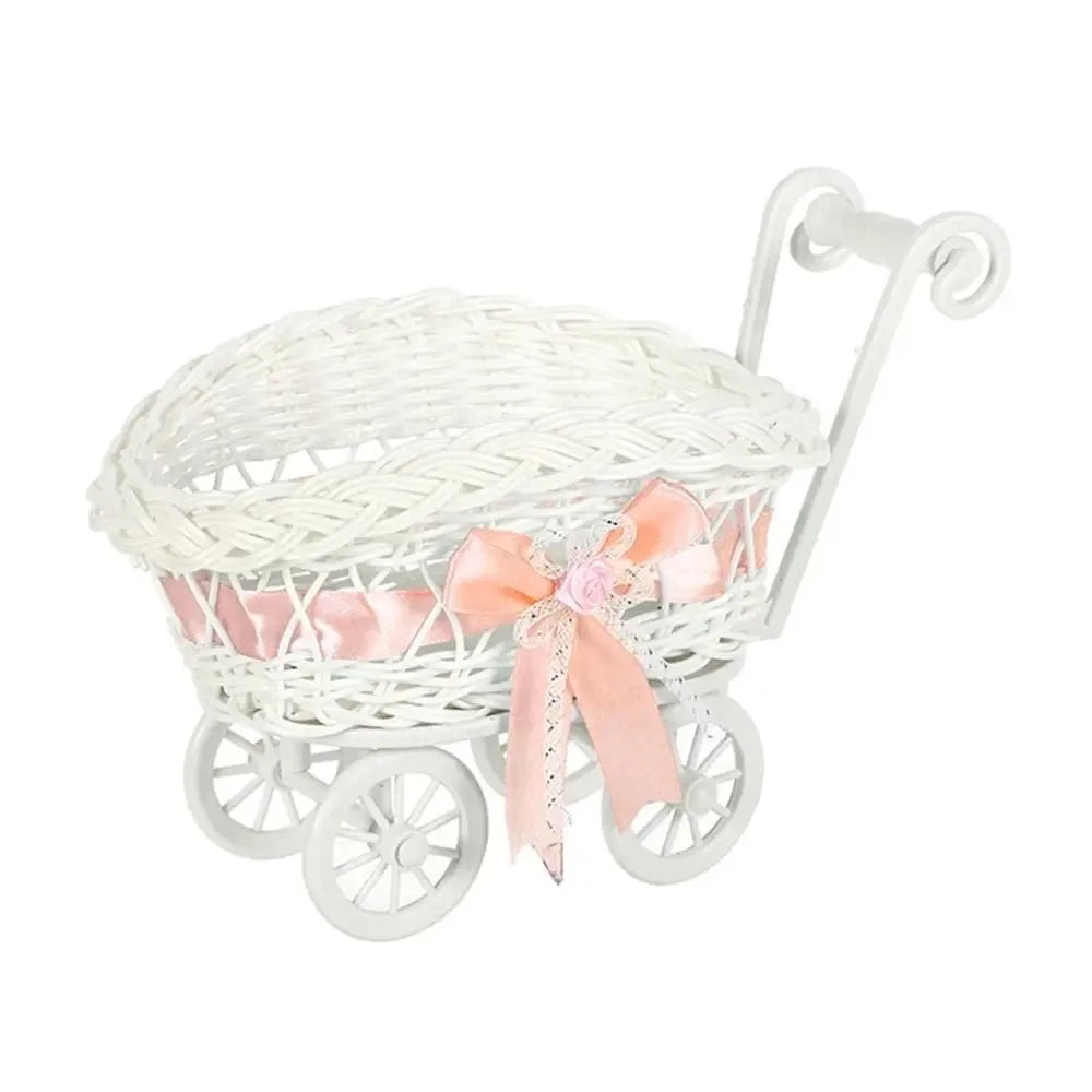 White faux rattan woven storage basket with a pink ribbon bow and handle