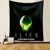 A black tapestry wall hanging featuring a glowing green alien head design with stars and the text ALIEN COLLECTION