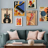 A gallery wall featuring abstract paintings of a guitar, cello, and piano against a gray wall.