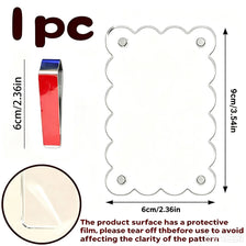 A clear acrylic frame with an oval pattern and protective film, shown next to a rectangular piece.