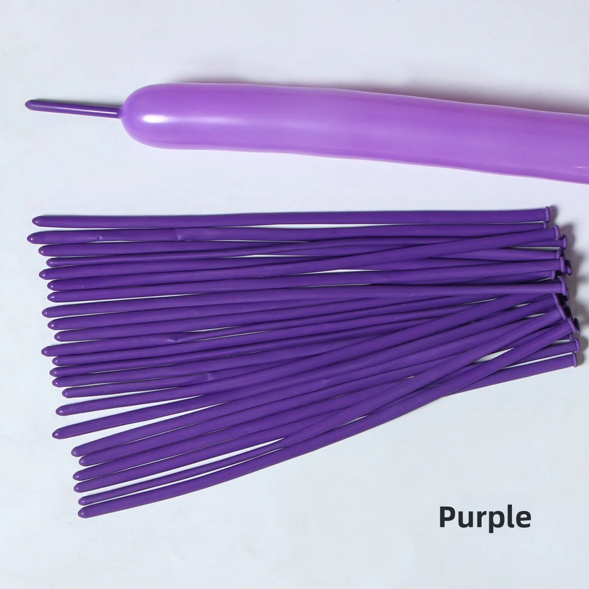 A collection of purple latex strip balloons with a purple applicator tool.