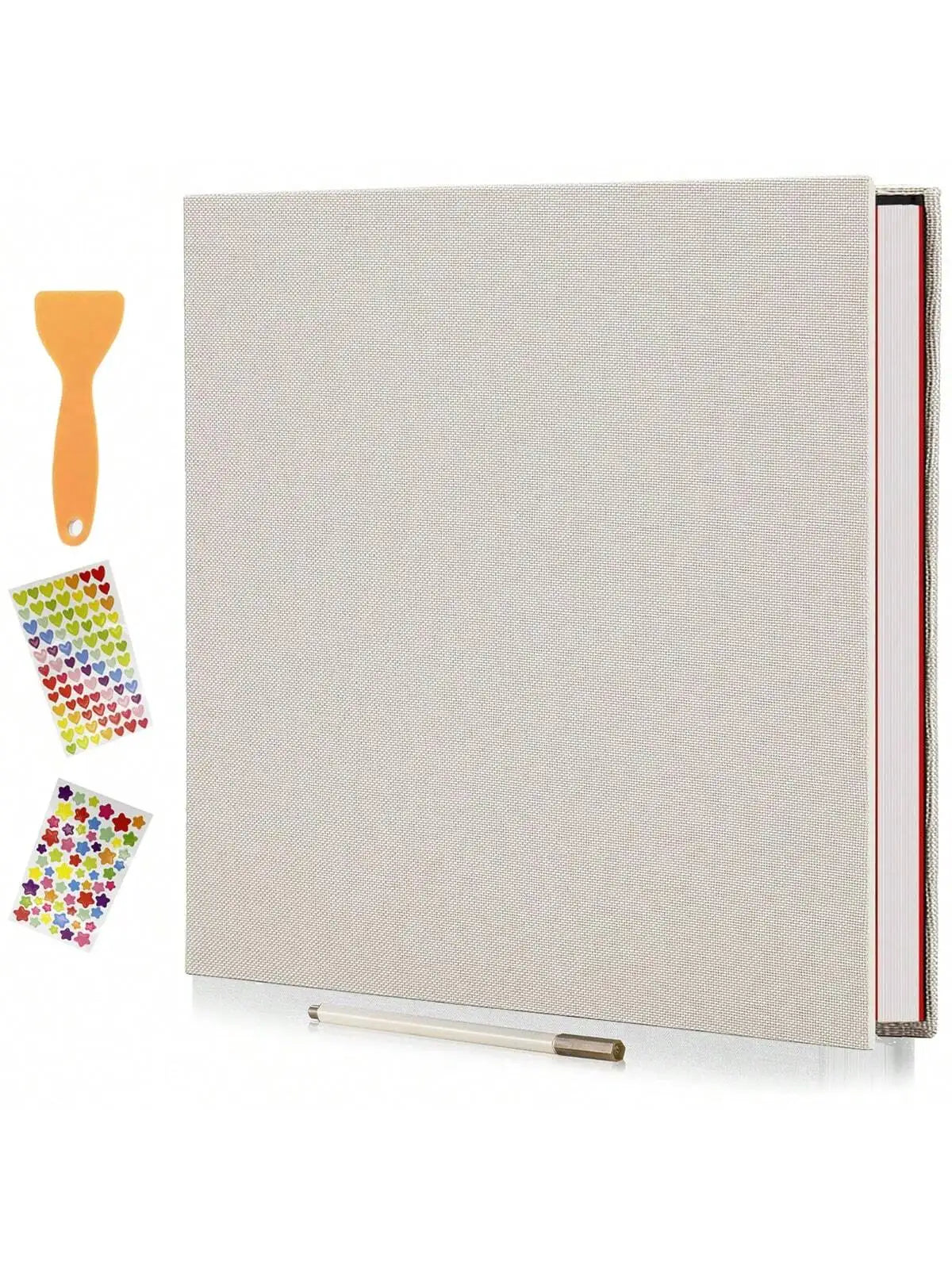 A grey linen scrapbook photo album with a spine showing red and white pages and an orange glue stick and colorful adhesive st